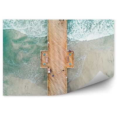 Samolepící fototapeta Molo muž oceán nebe mraky západ slunce