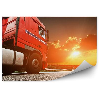 Fototapeta Červený kamion v pozadí při západu slunce