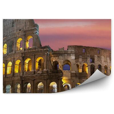 Samolepící fototapeta Osvětlené Koloseum na pozadí barevné oblohy