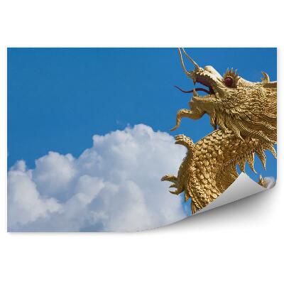 Fototapeta Zlatý drak létající mezi mraky na modré obloze