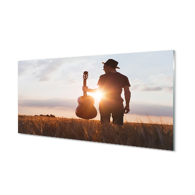 Skleněný obraz Muž na louce s kytarou